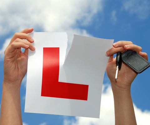 Learner successfully passing driving test with examiner